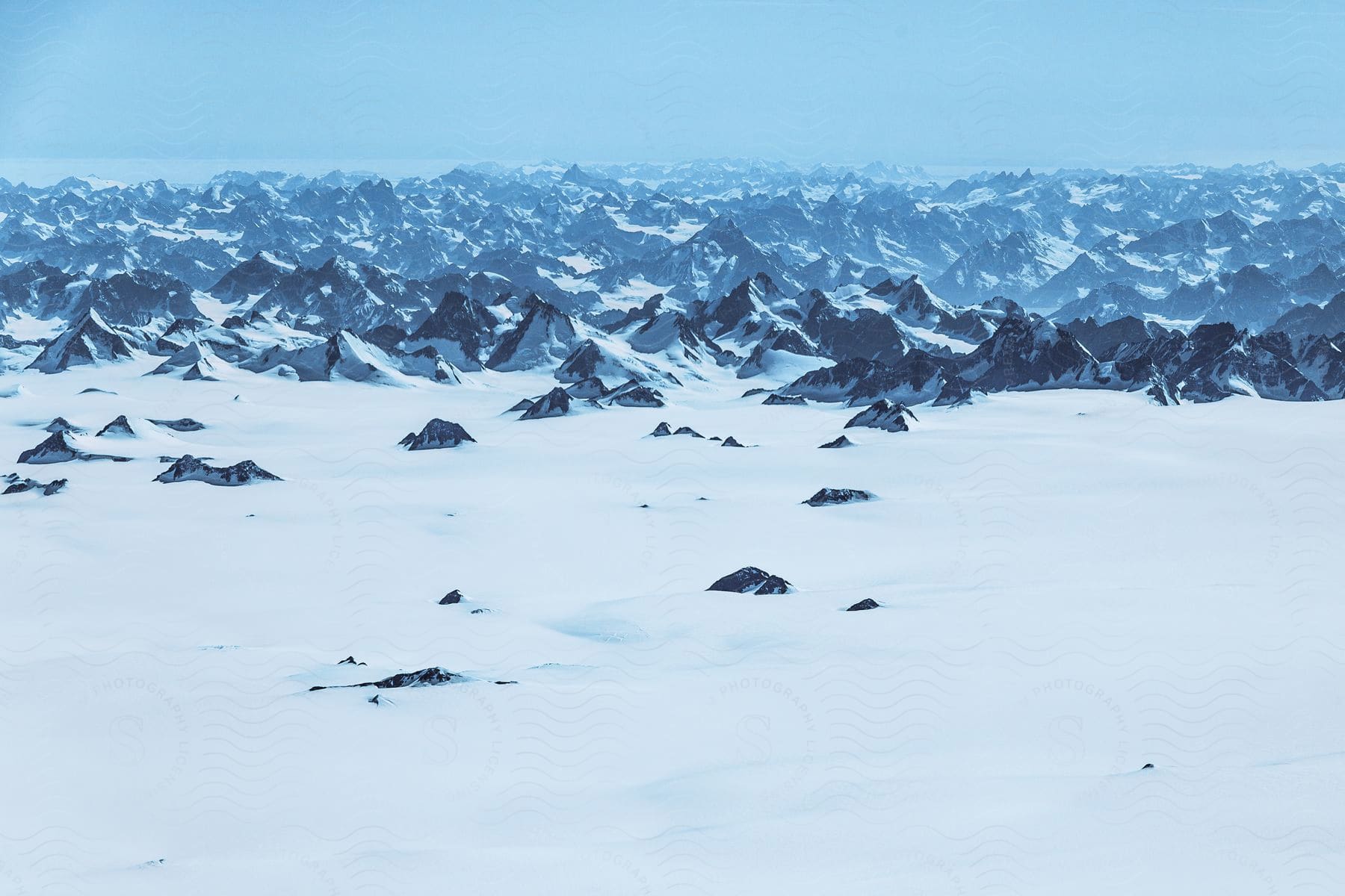 Snowy mountains stretching away in an aerial perspective