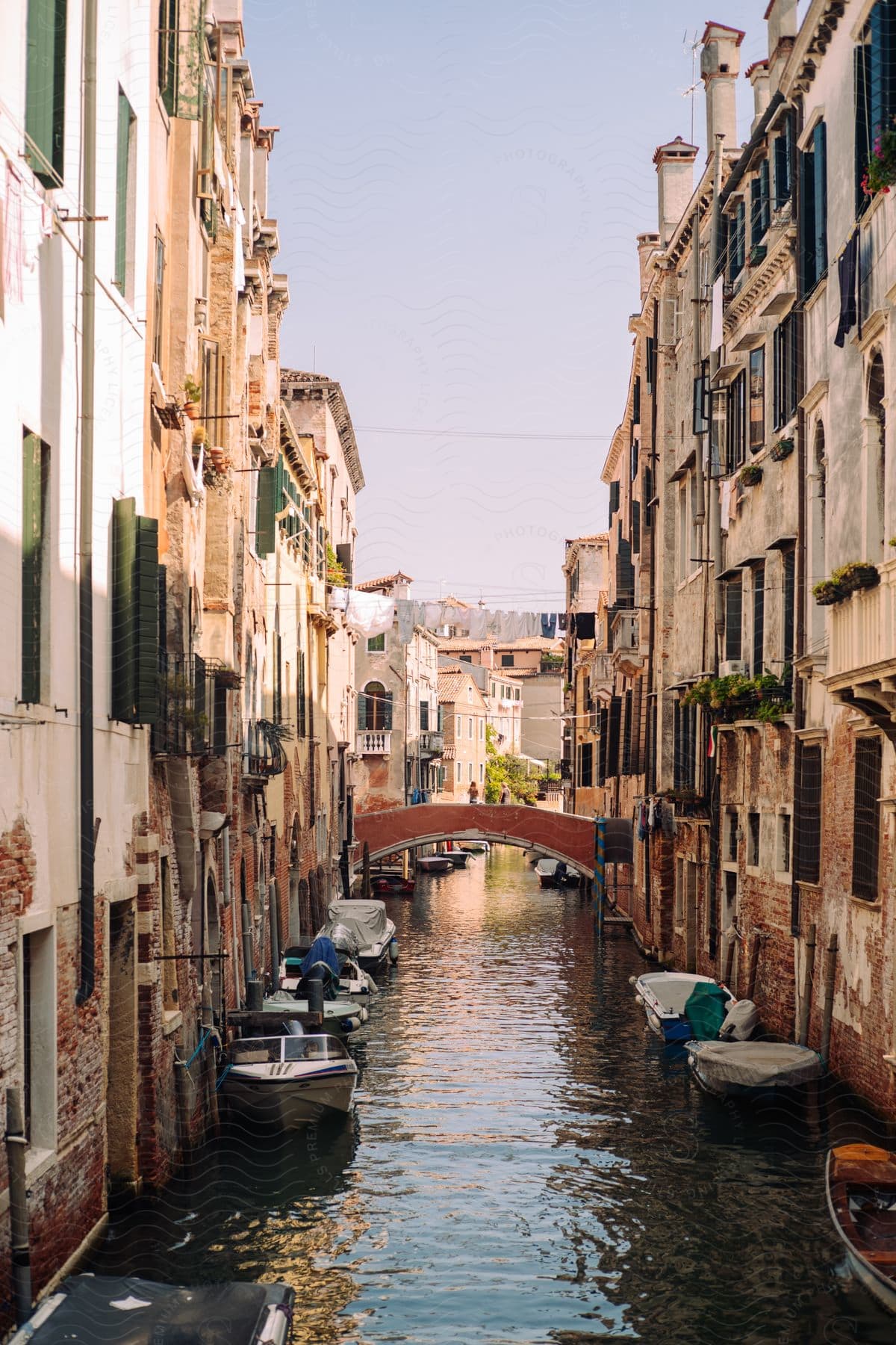 A canal in a european city lined with boats and historical residential buildings