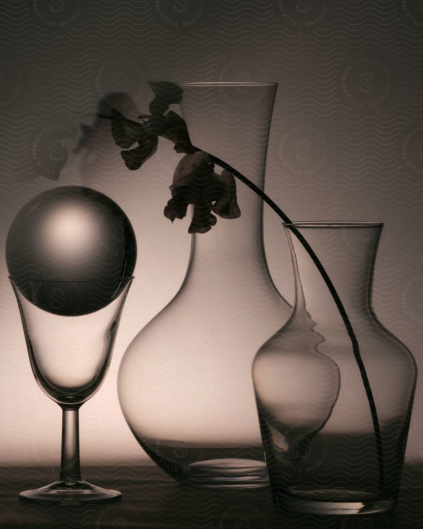 A glass of cups on a table in a lowkey interior setting at dusk or dawn