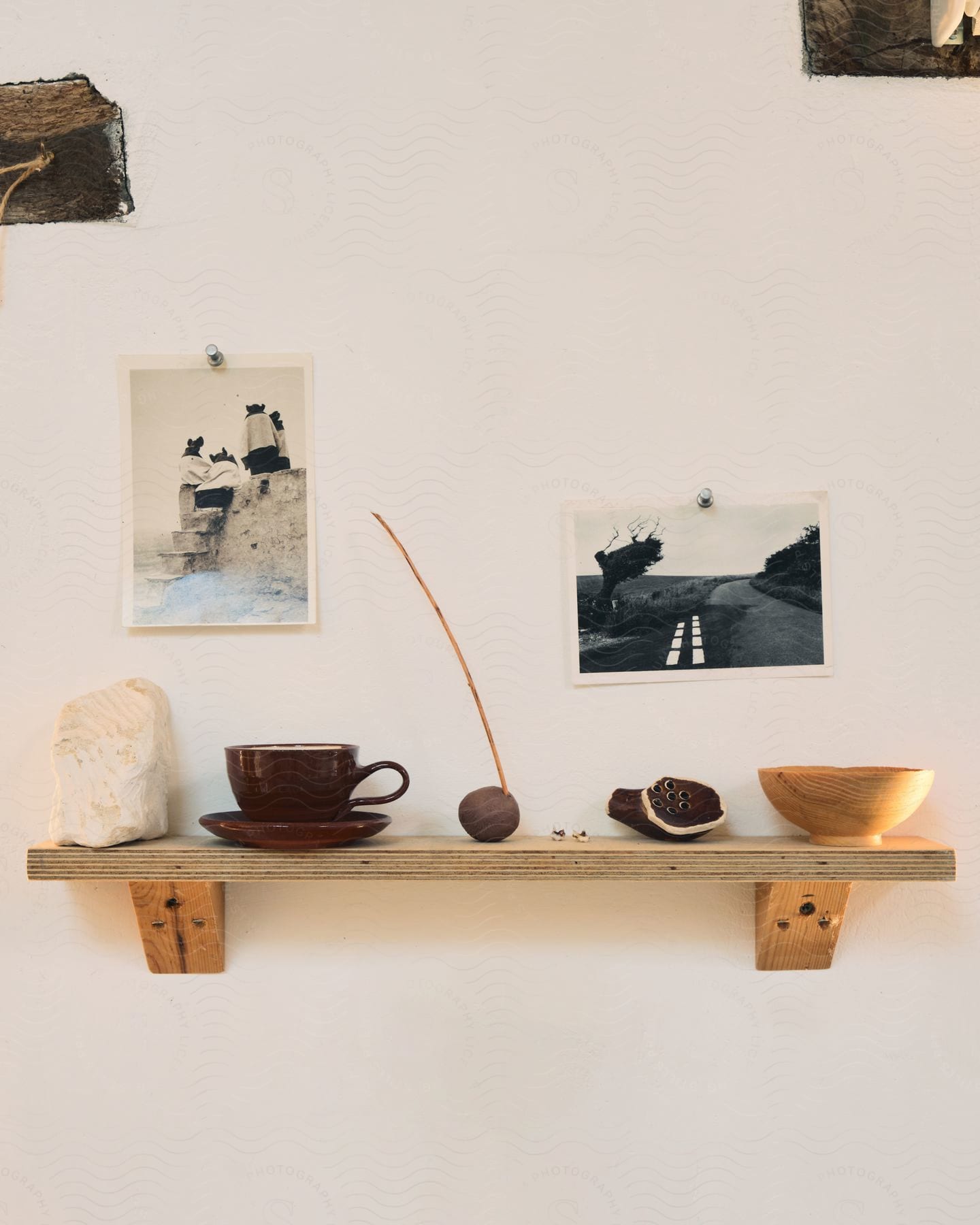 Wooden wall shelf with decorations and pictures on the wall in an interior space