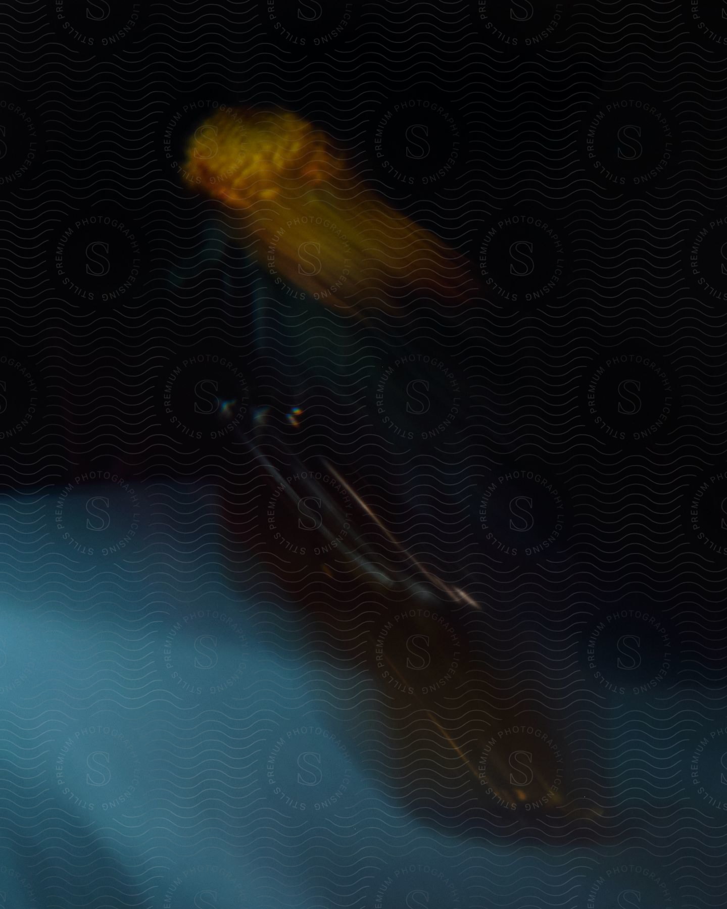 A blurred abstract image in a dark setting