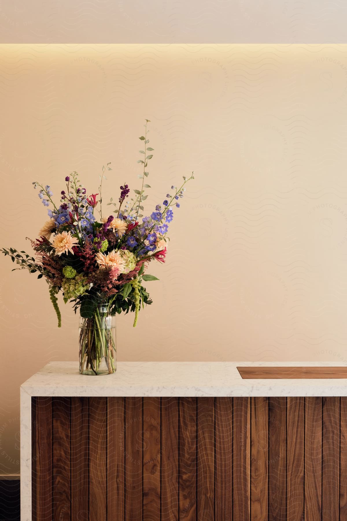 A wooden table with a vase of flowers