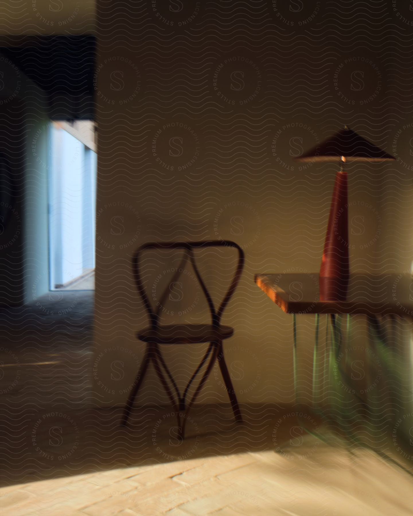 An empty room with a table chair and lamp