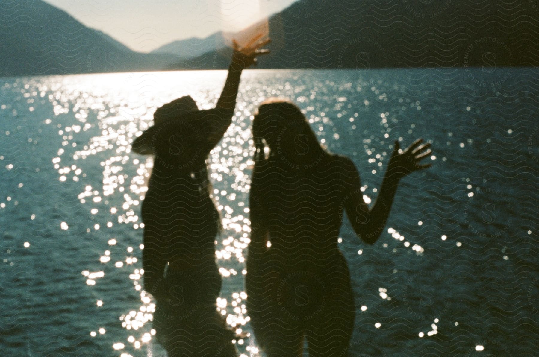 Two women having fun while bathing outside in the sunlight