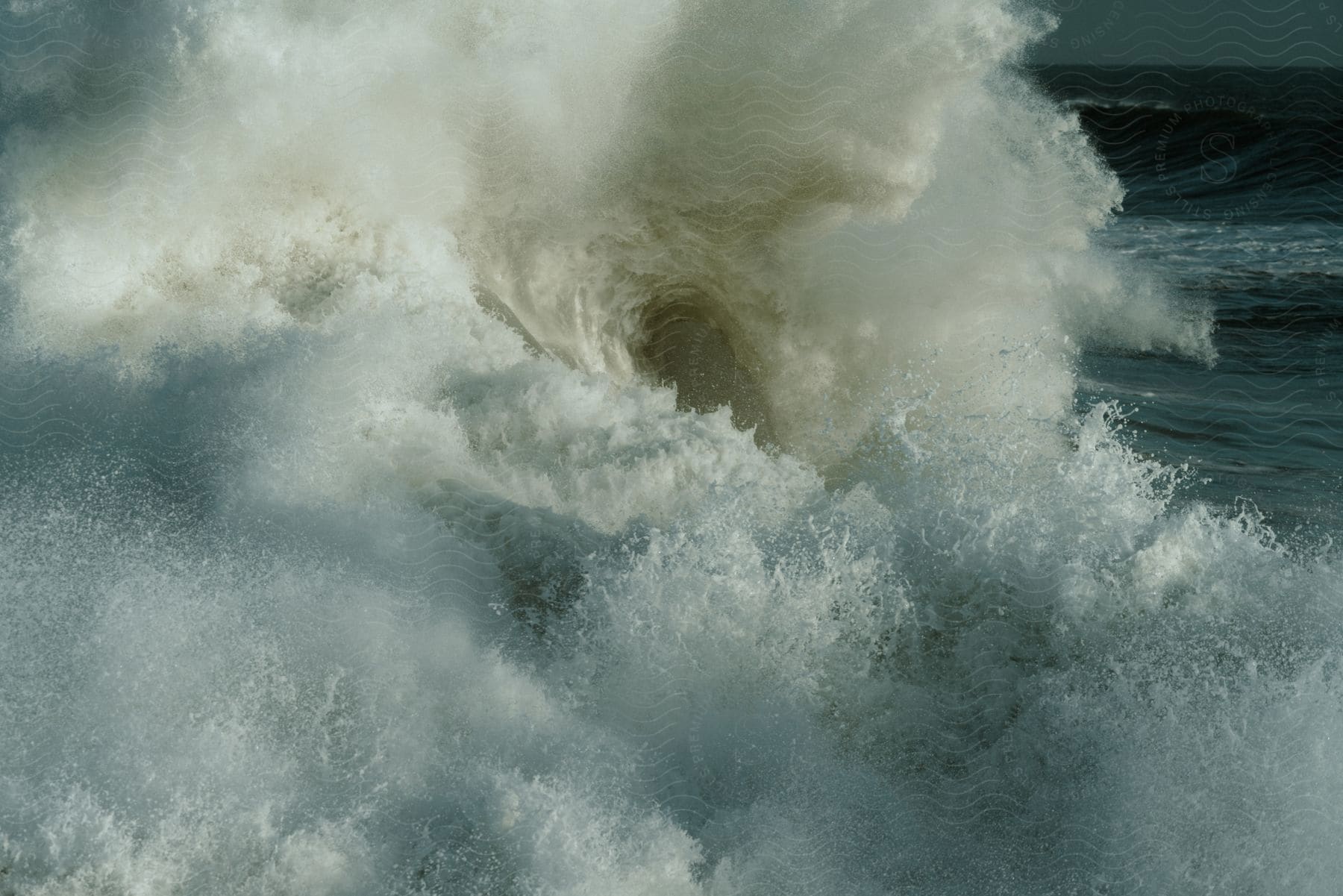 A large wave crashing in the ocean