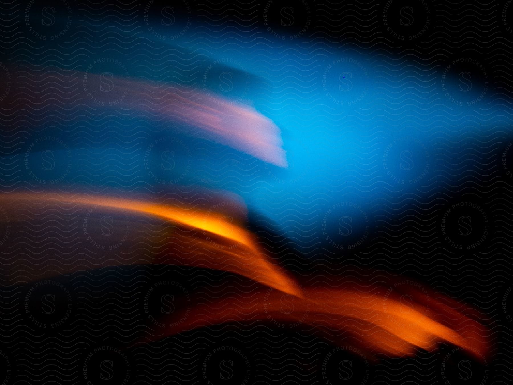 Blurred Motion Of A Persons Face Against A Blue And Black Background