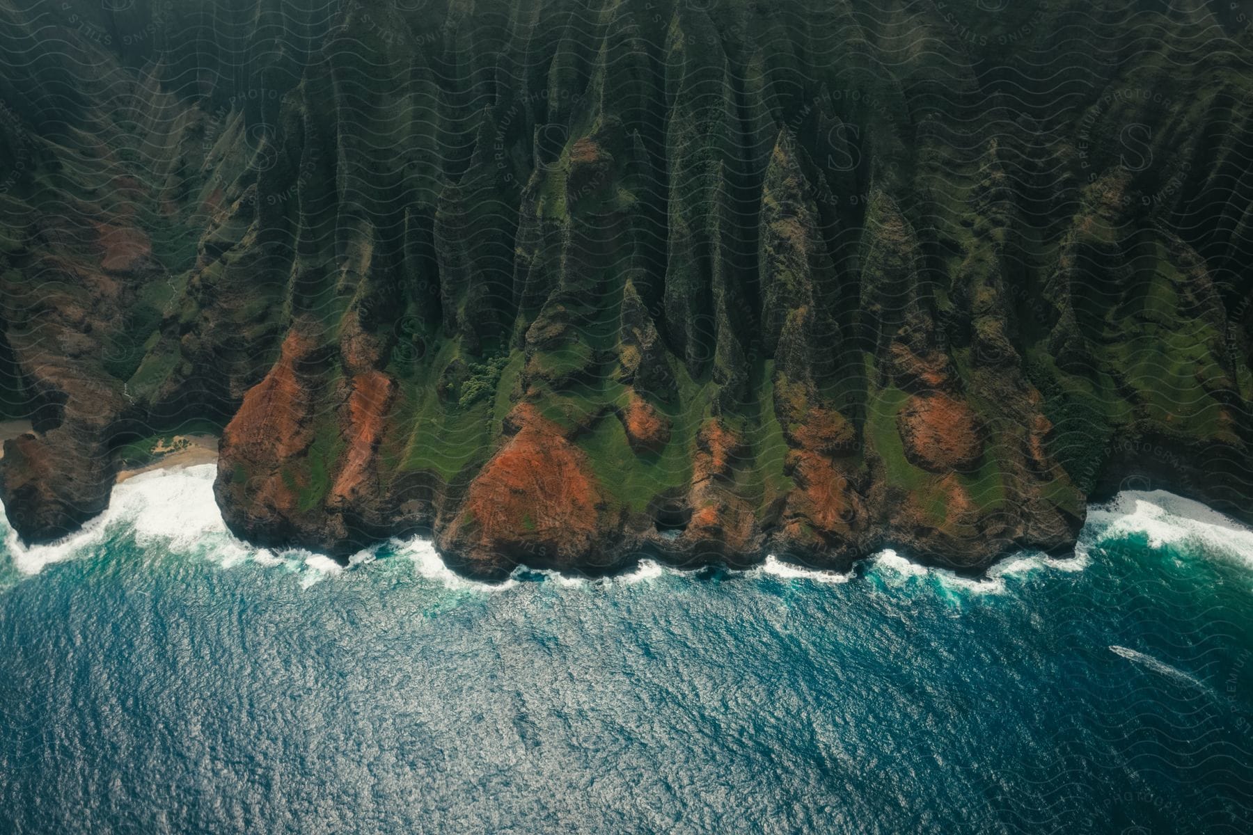 Aerial view of a coastal landscape with mountains and a watercourse