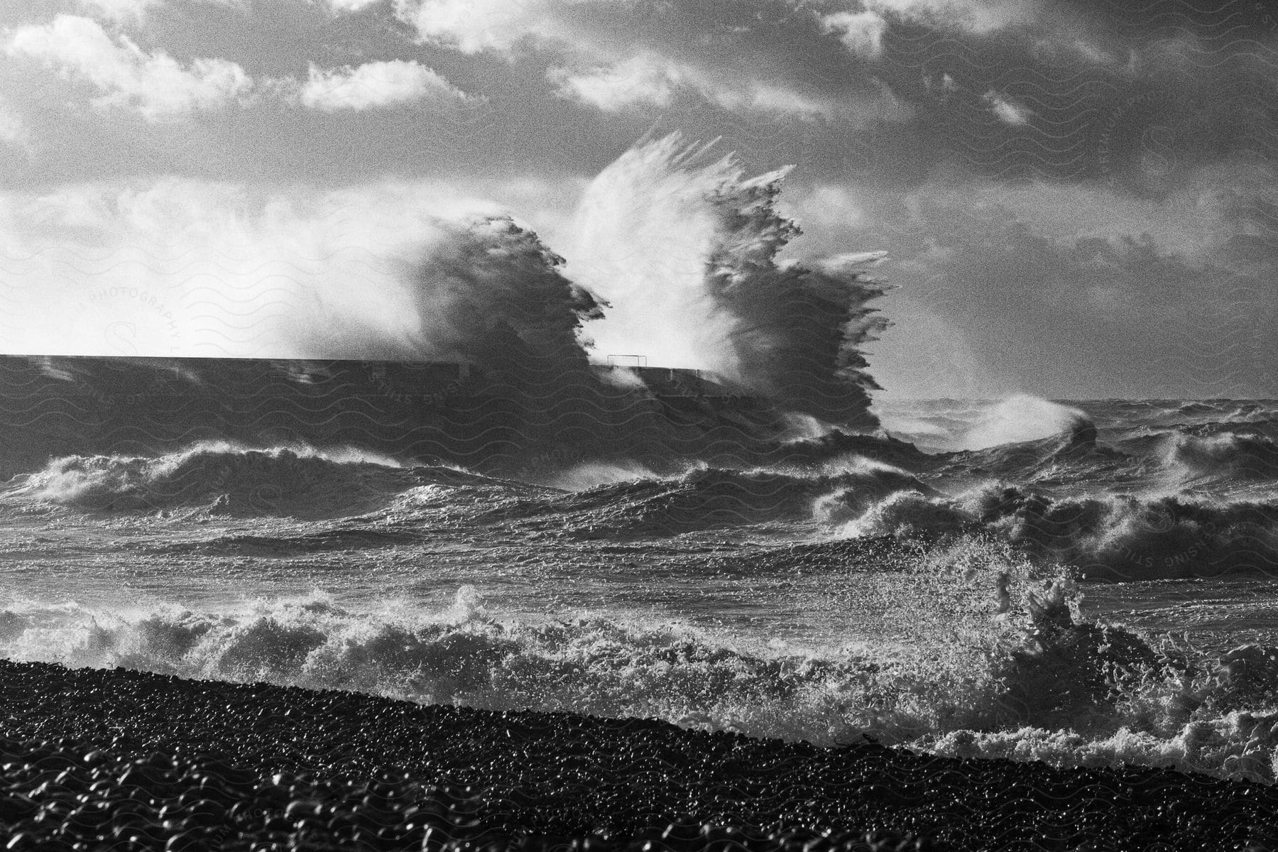 Waves crash on the beach on a cloudy day in brighton