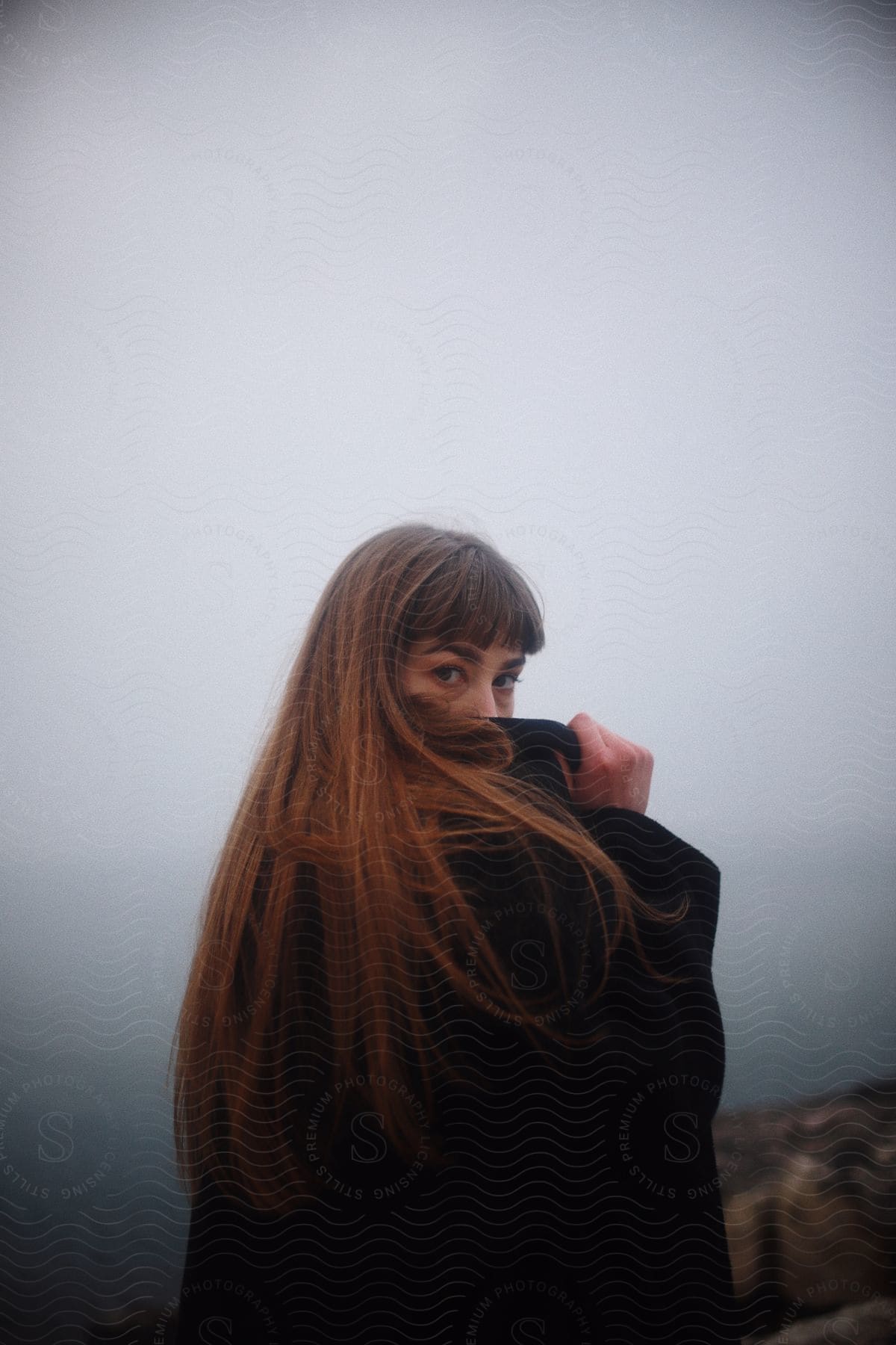 Woman standing outdoors wearing a coat