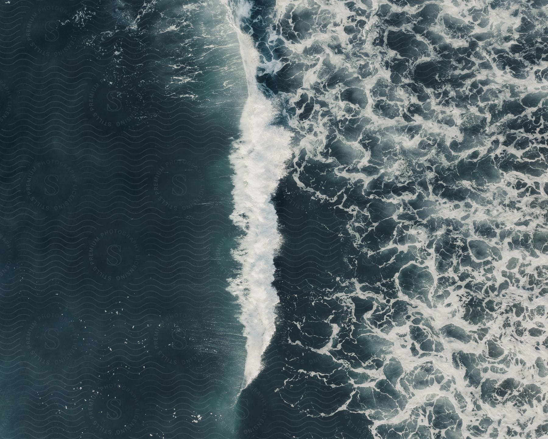 A serene scene of the sea with waves crashing on the shoreline and clouds in the sky