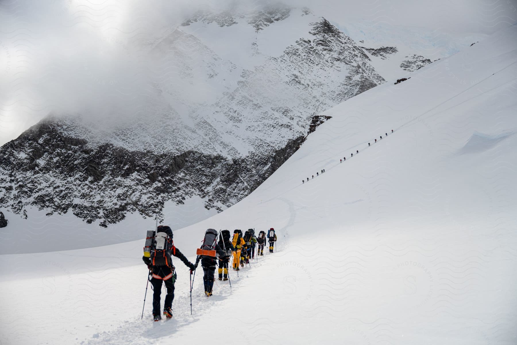 Two groups of hikers climbing a snowcovered mountain in antarctica