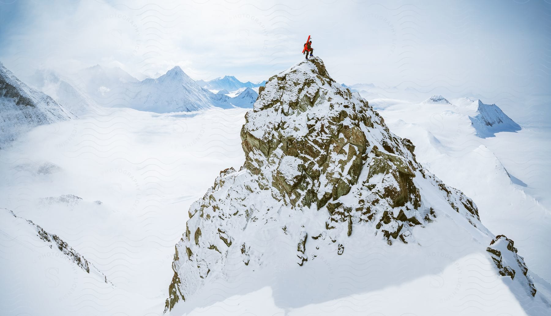 A person standing on a mountain top in antarctica