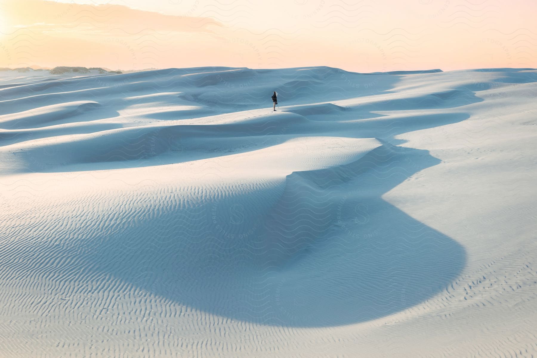 A person stands on a snowy slope in iceland