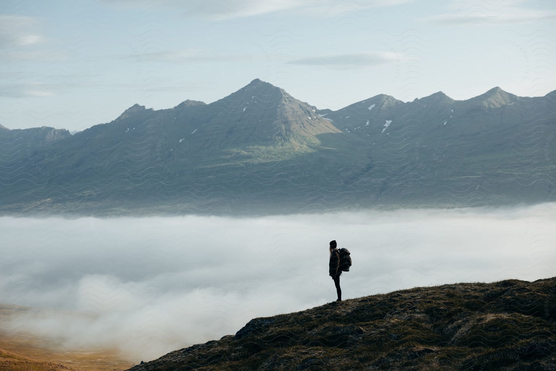 A woman hiking outdoors during a cloudy day