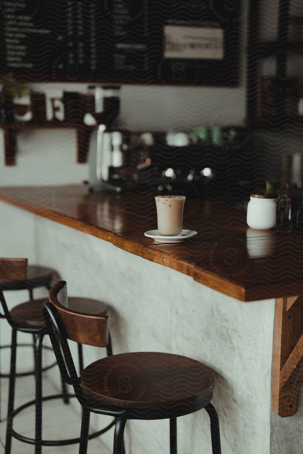 A cappuccino sits on a bar in a cafe