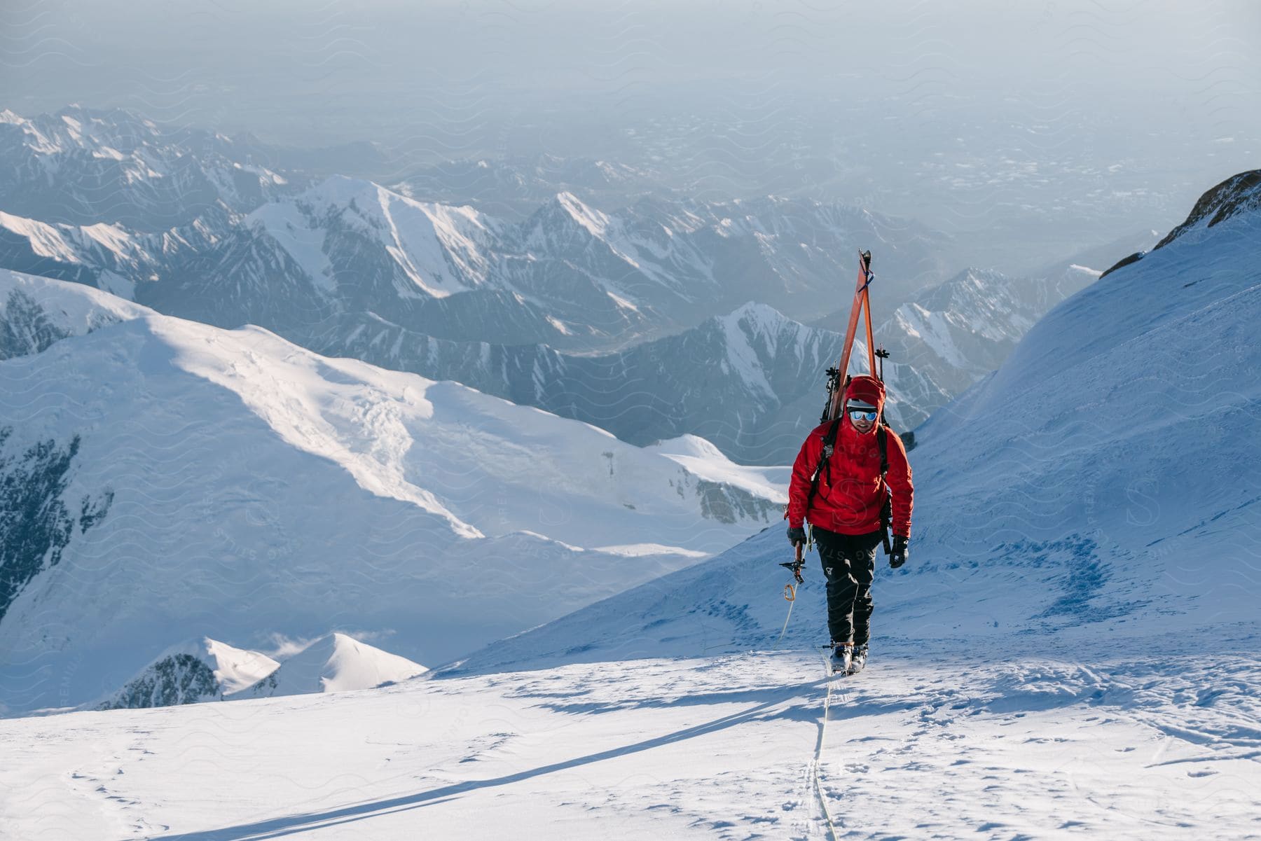 A man hikes along a snowcovered mountain