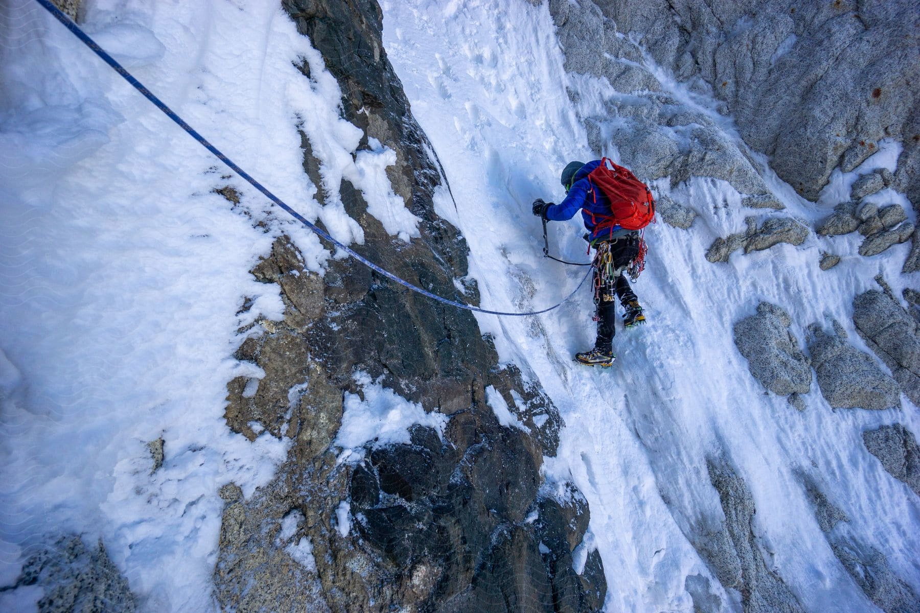 An ice climber clinging to an icy cliff in el chalten patagonia