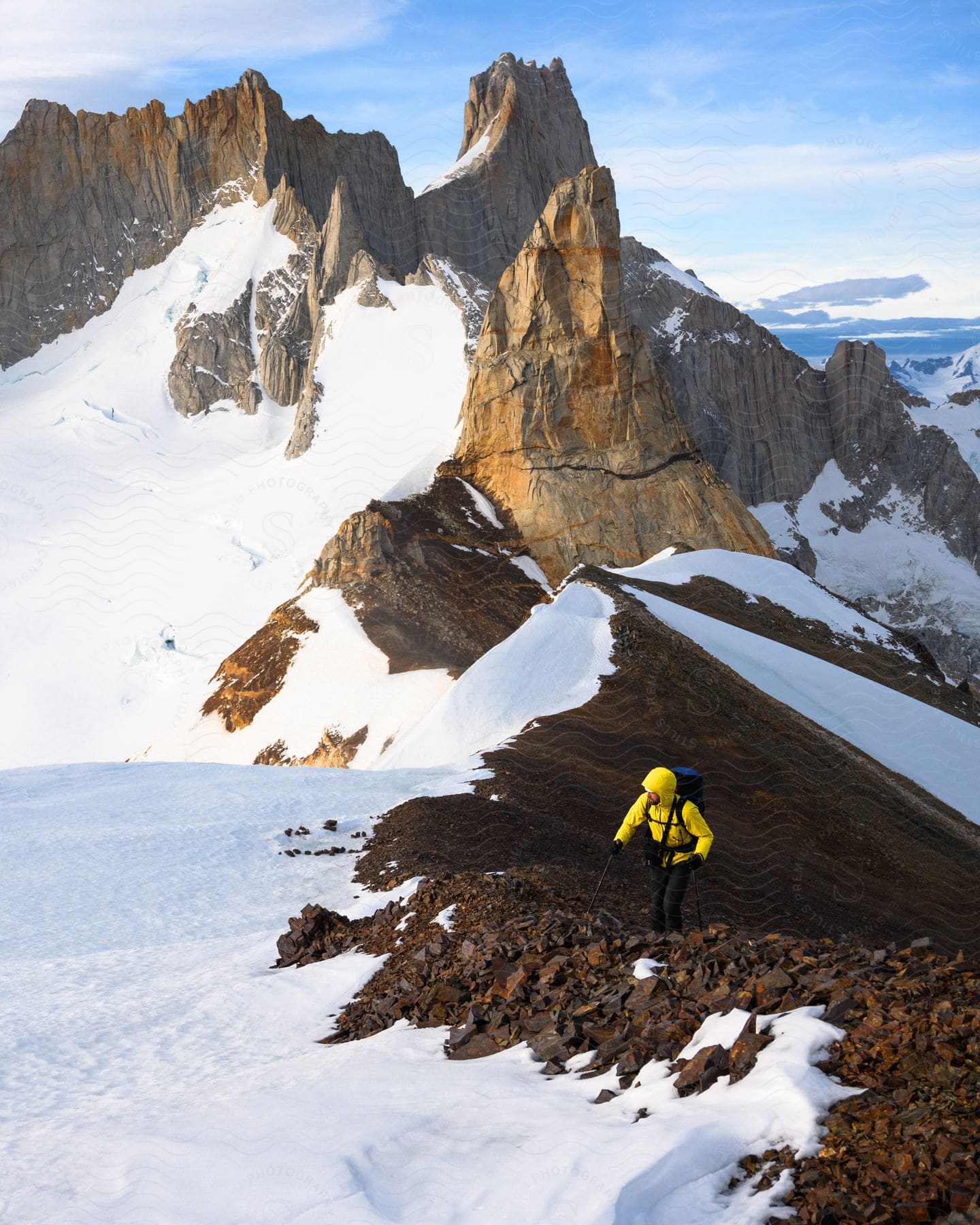 A man hikes along a snowcovered mountain in el chalten patagonia