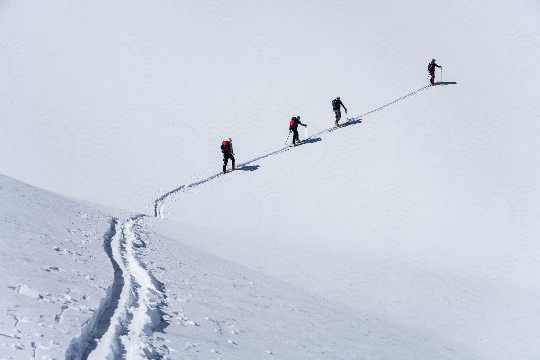 Snowcovered flat landscape with a group of people engaged in outdoor activity in uintas utah