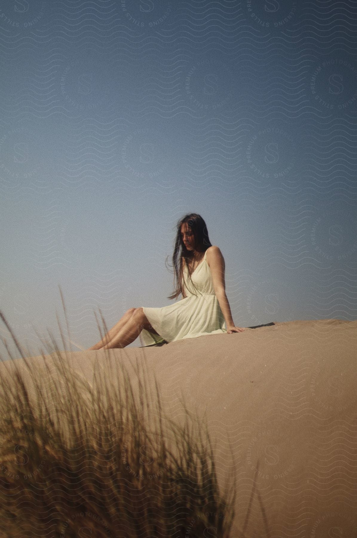 A happy woman sitting outdoors in nature