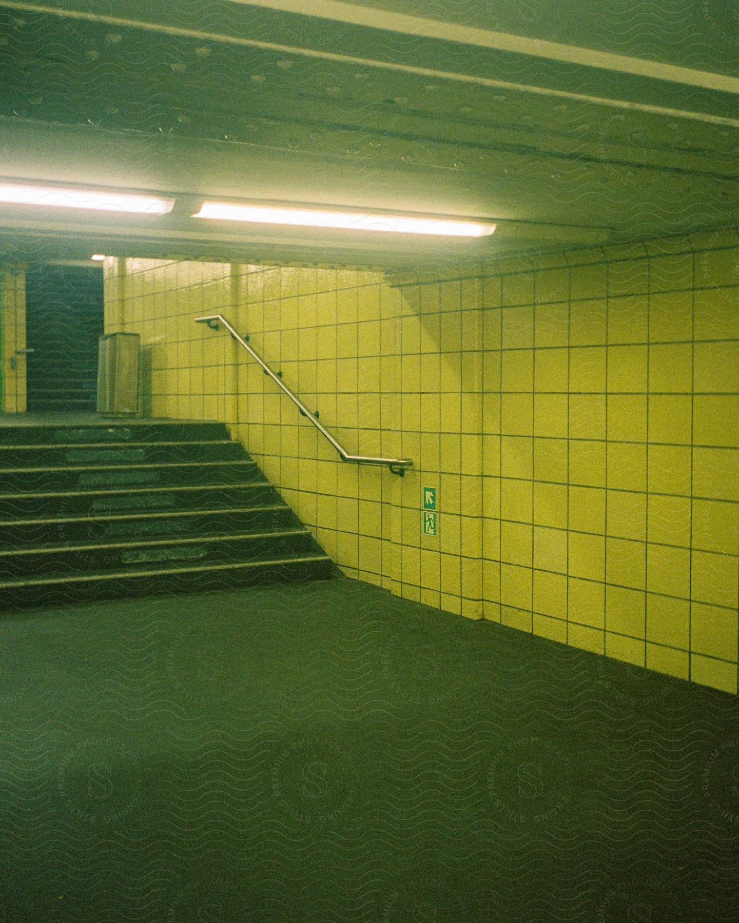 Lit hall with prominent staircase and long bulb casting warm glow creating inviting atmosphere