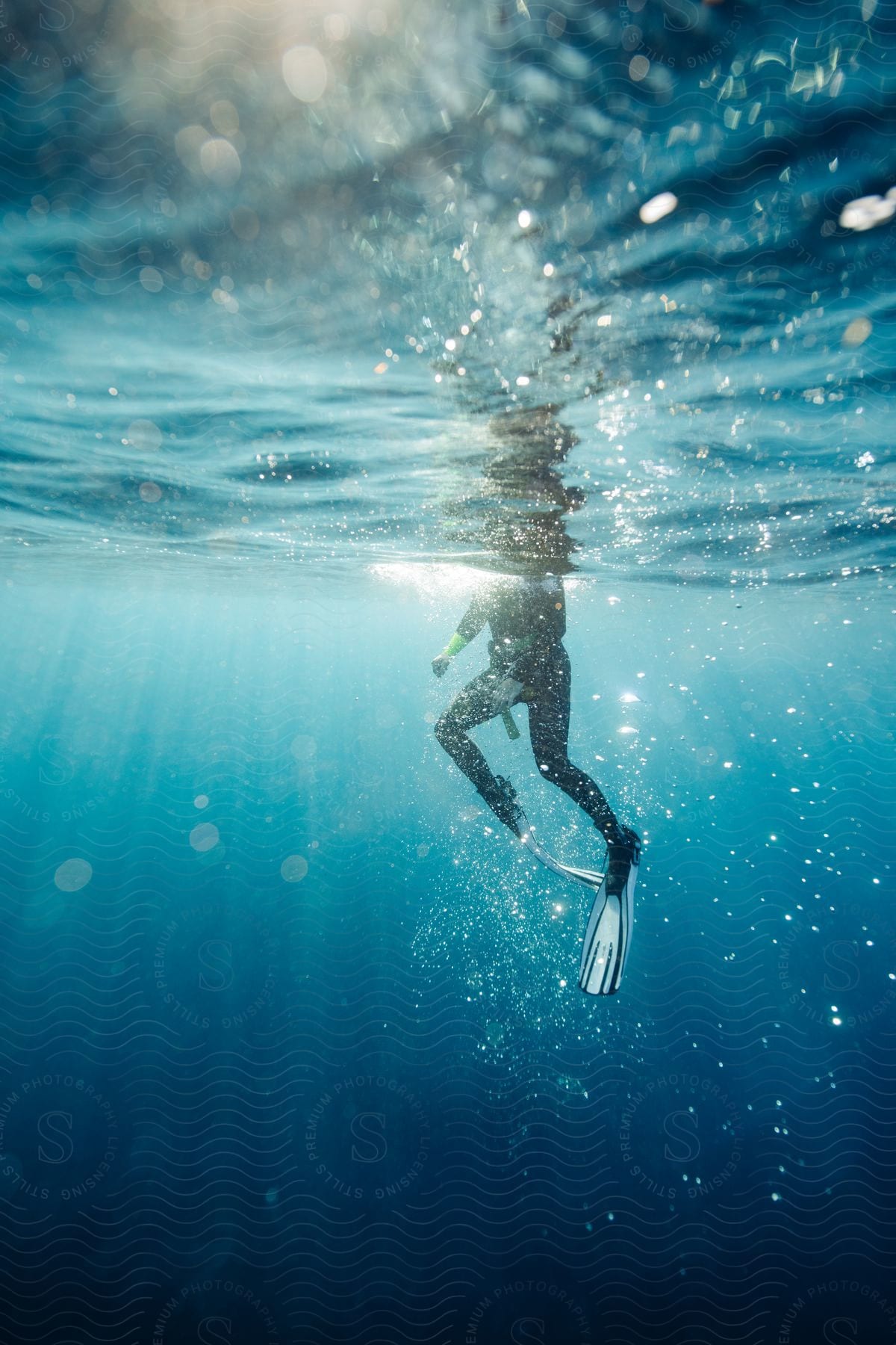 A scuba diver underwater surrounded by bubbles