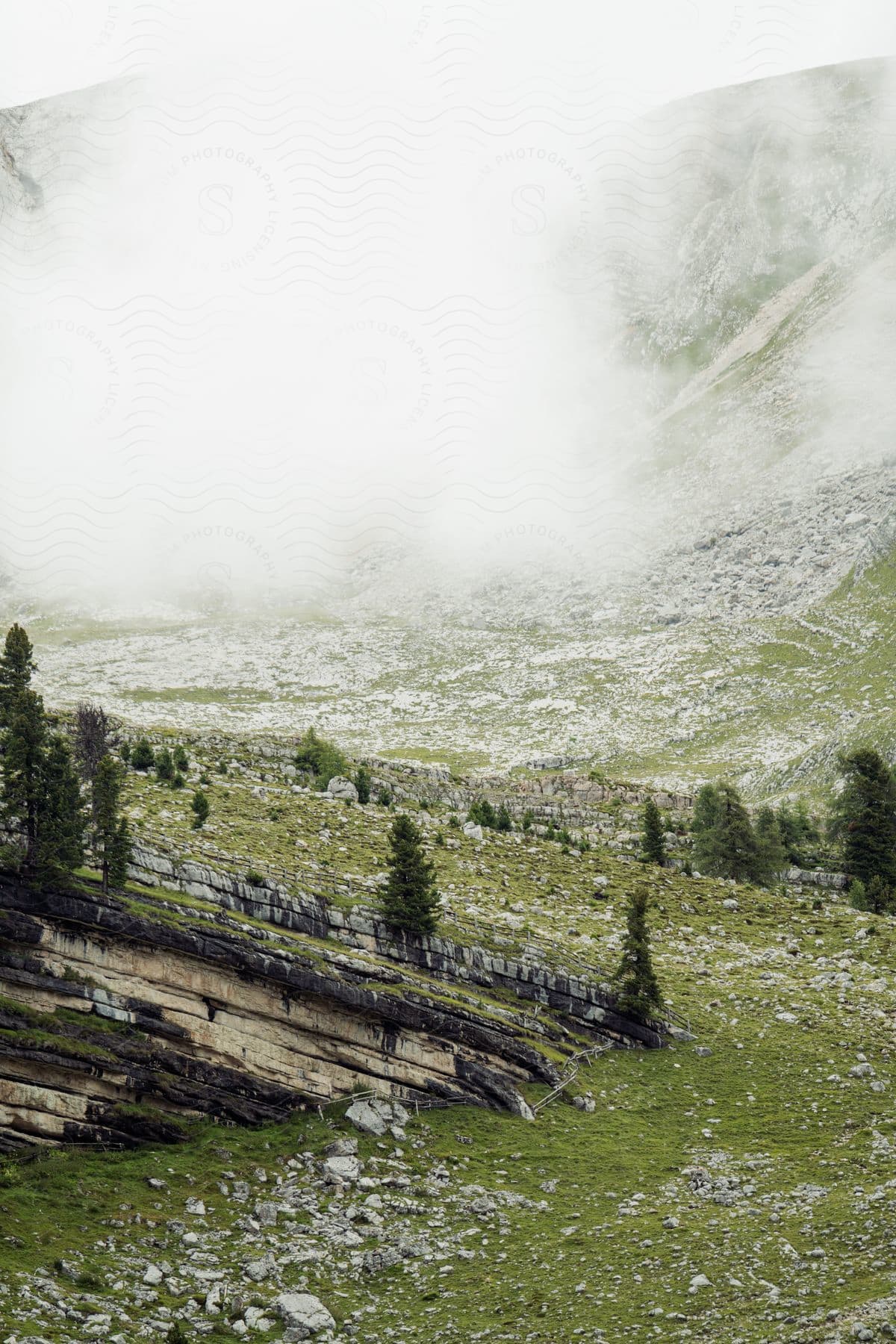 A snowcovered mountain with clouds in the alps