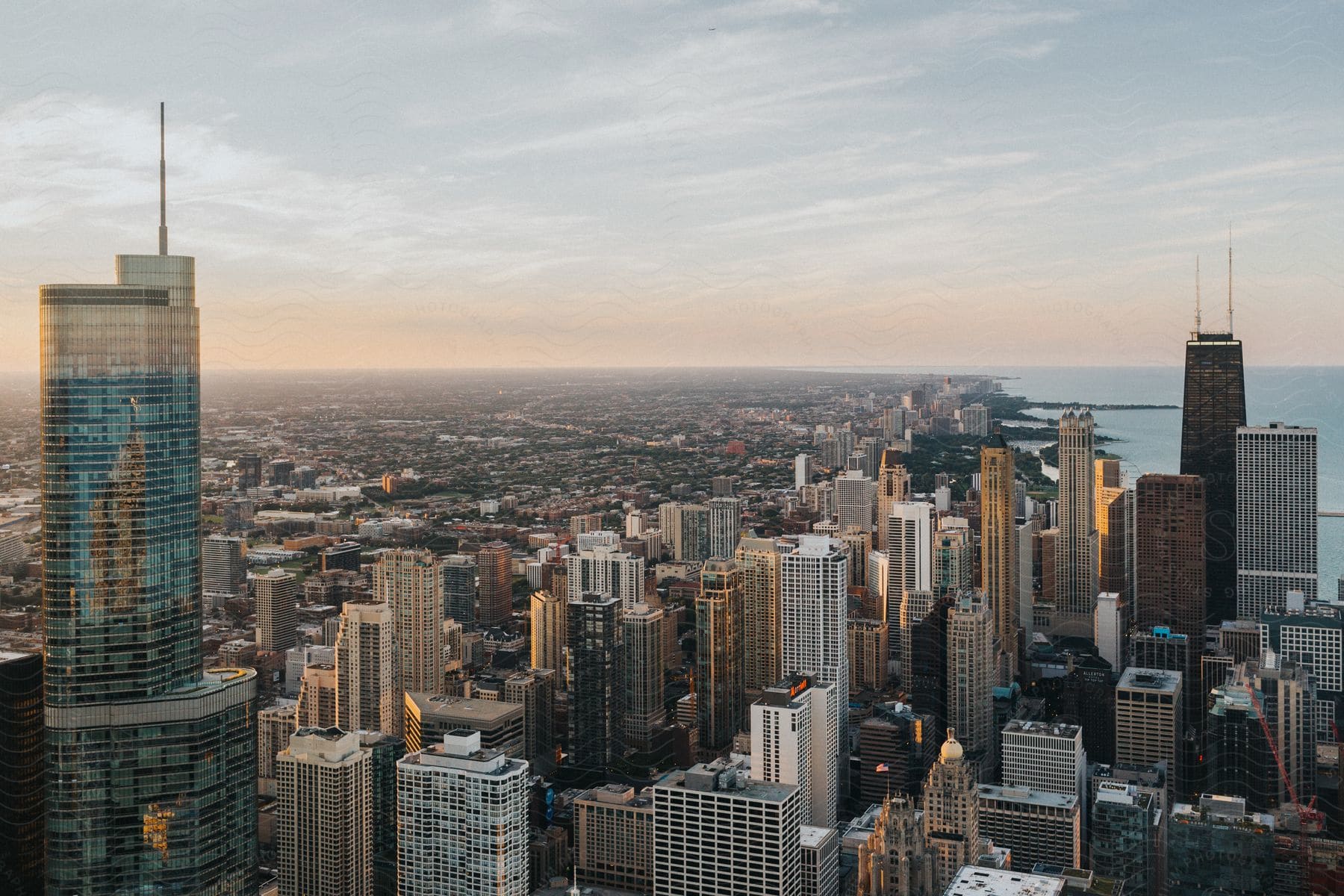 Chicago skyline with lake michigan and sears tower at sunrise seen from above