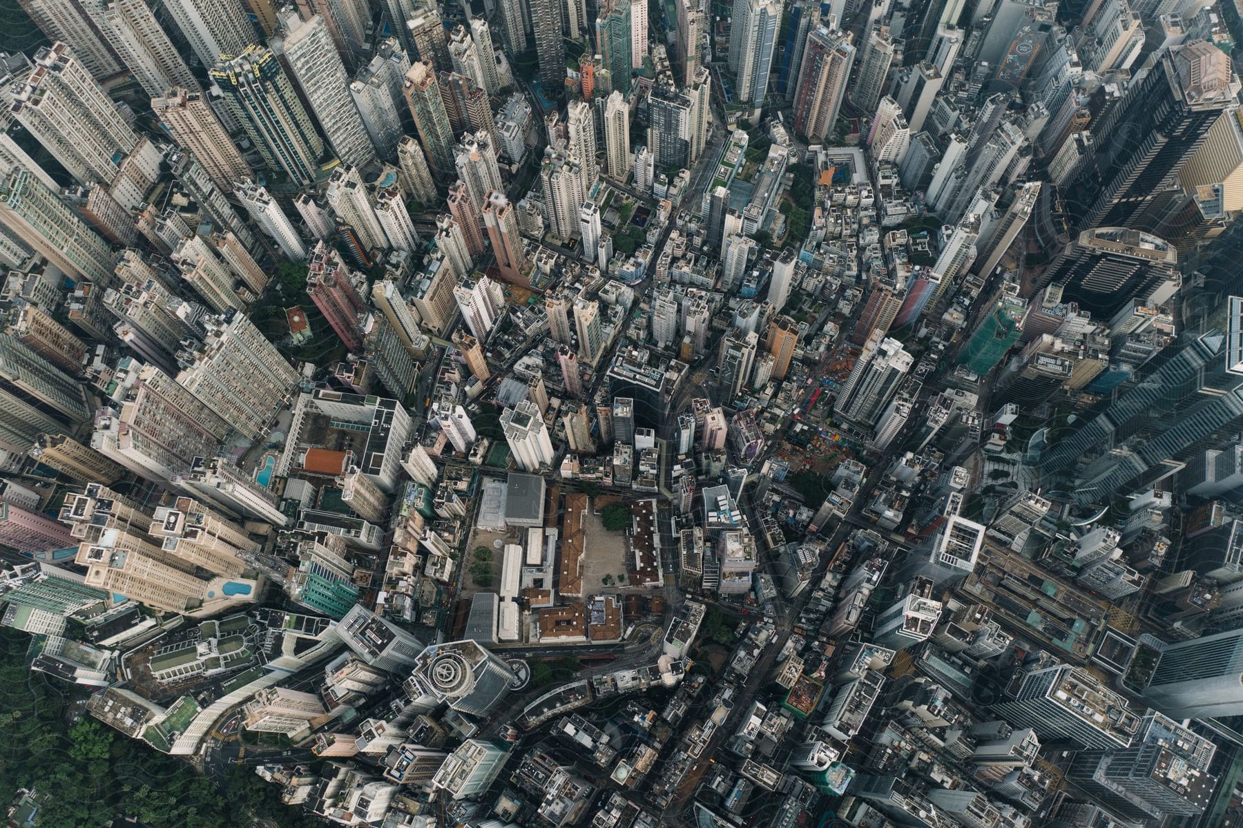 An aerial view of a dense metropolis city with tall buildings and city streets