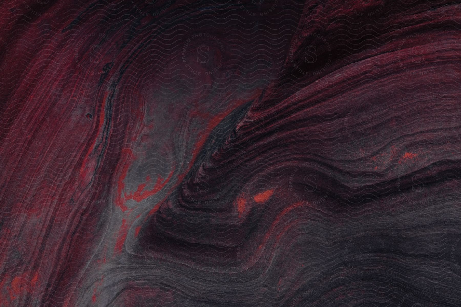 Deep red and grey lines and patterns resembling the lines on a topographical map