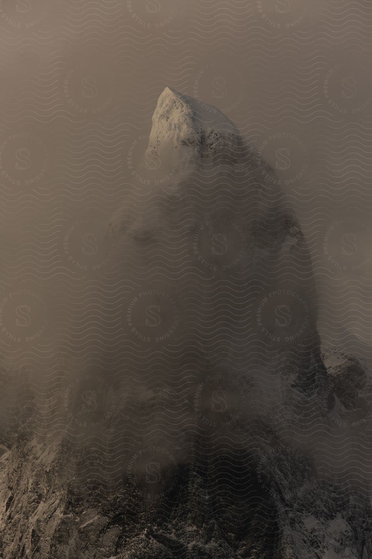 A snowy mountain peak is visible from above at night