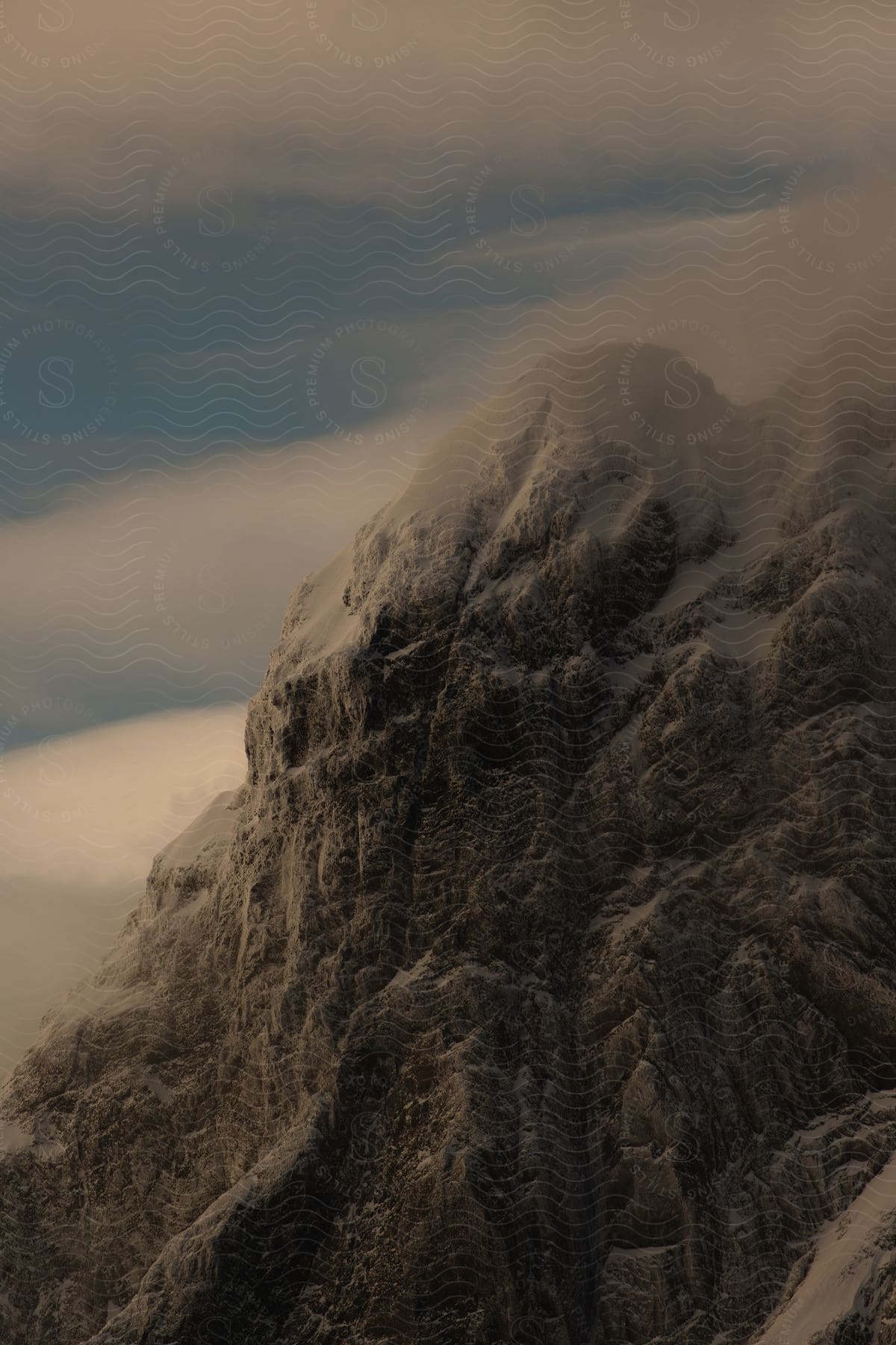 Snow covered mountains during dusk in an aerial photograph