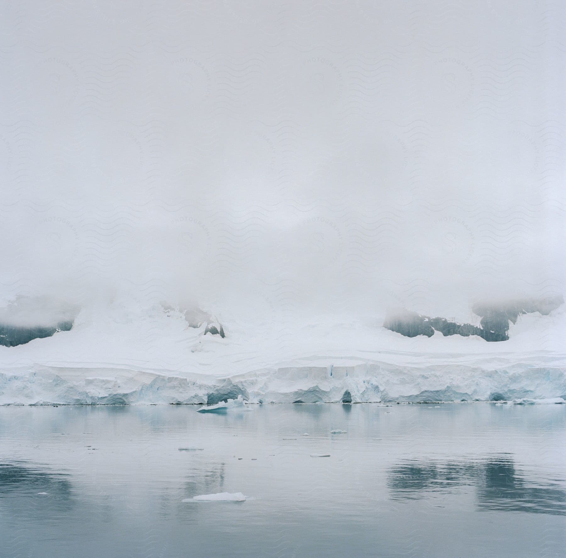 Snowcovered land mass meeting the ocean