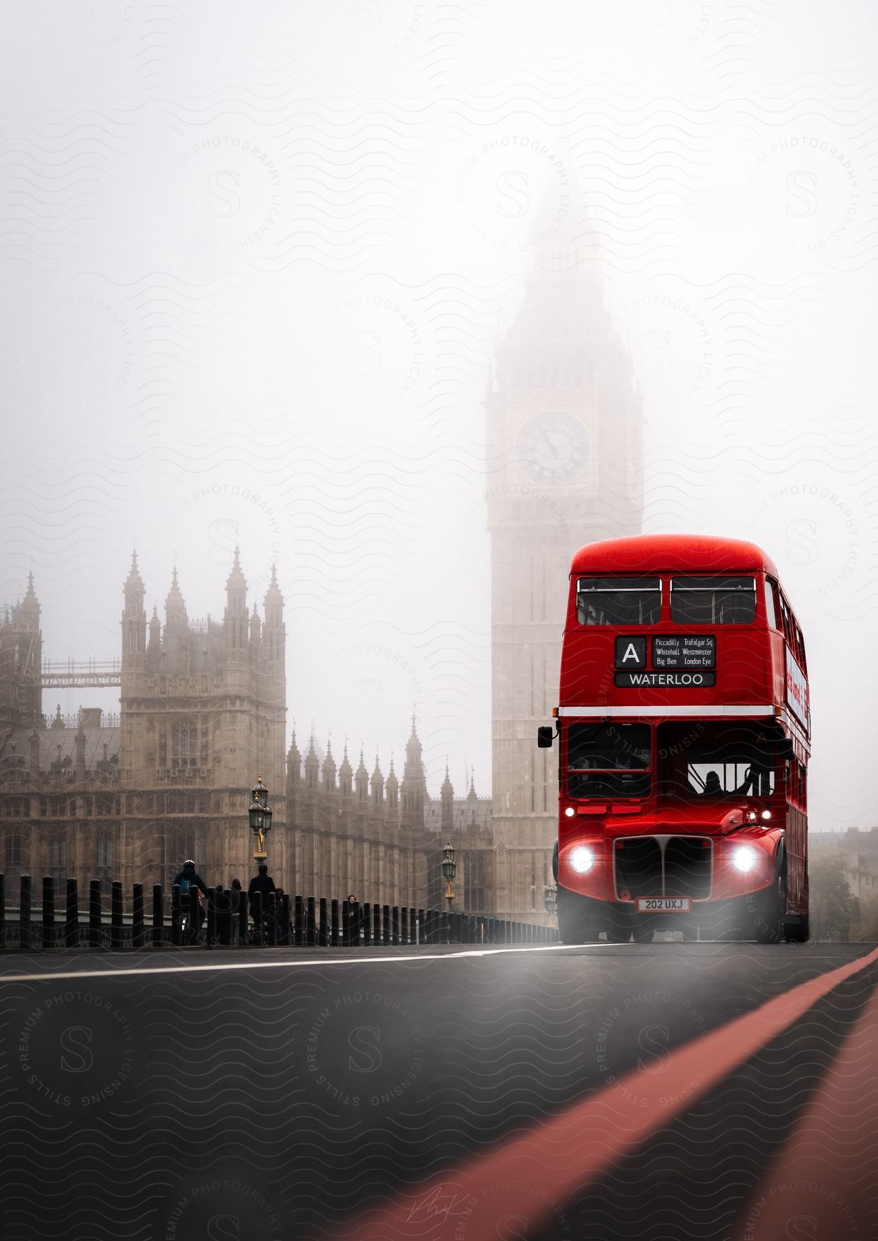 London in the fog with a red doubledecker bus and big ben as a backdrop