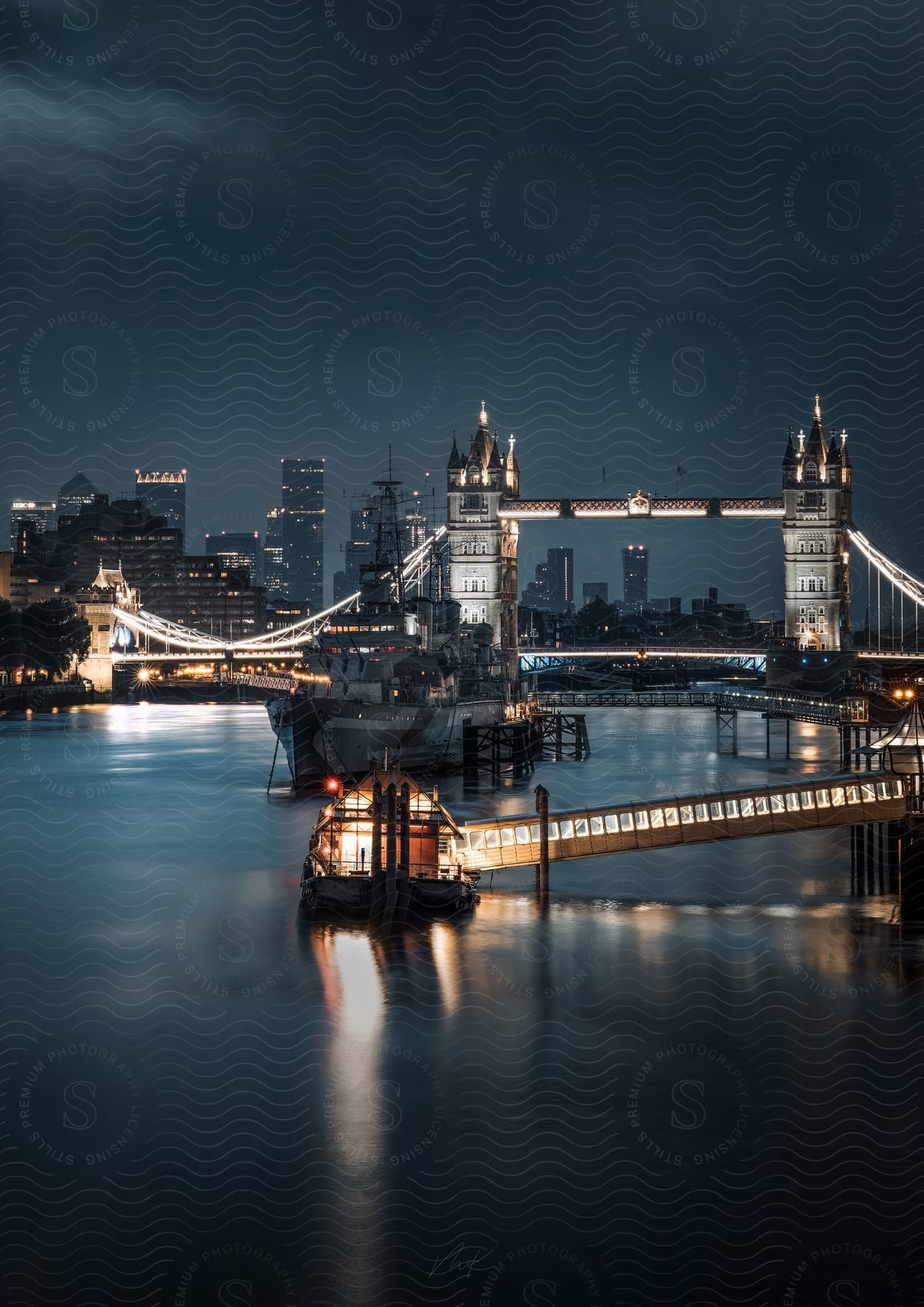 Boats in the harbor at tower bridge london at night