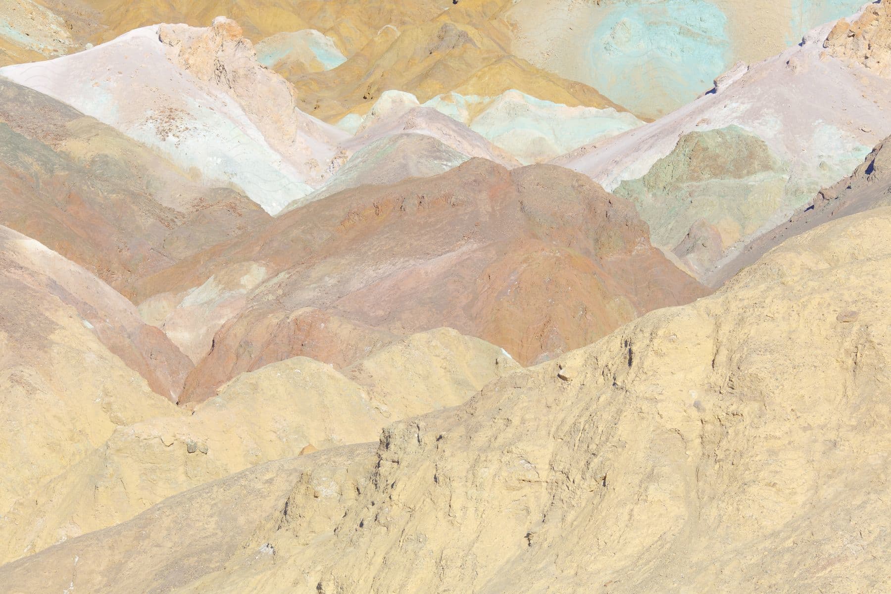 Desert hills in shades of blue pink and brown blend together