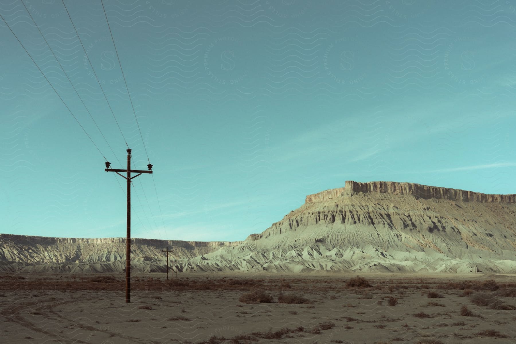 A mountainous landscape with a utility pole in the foreground