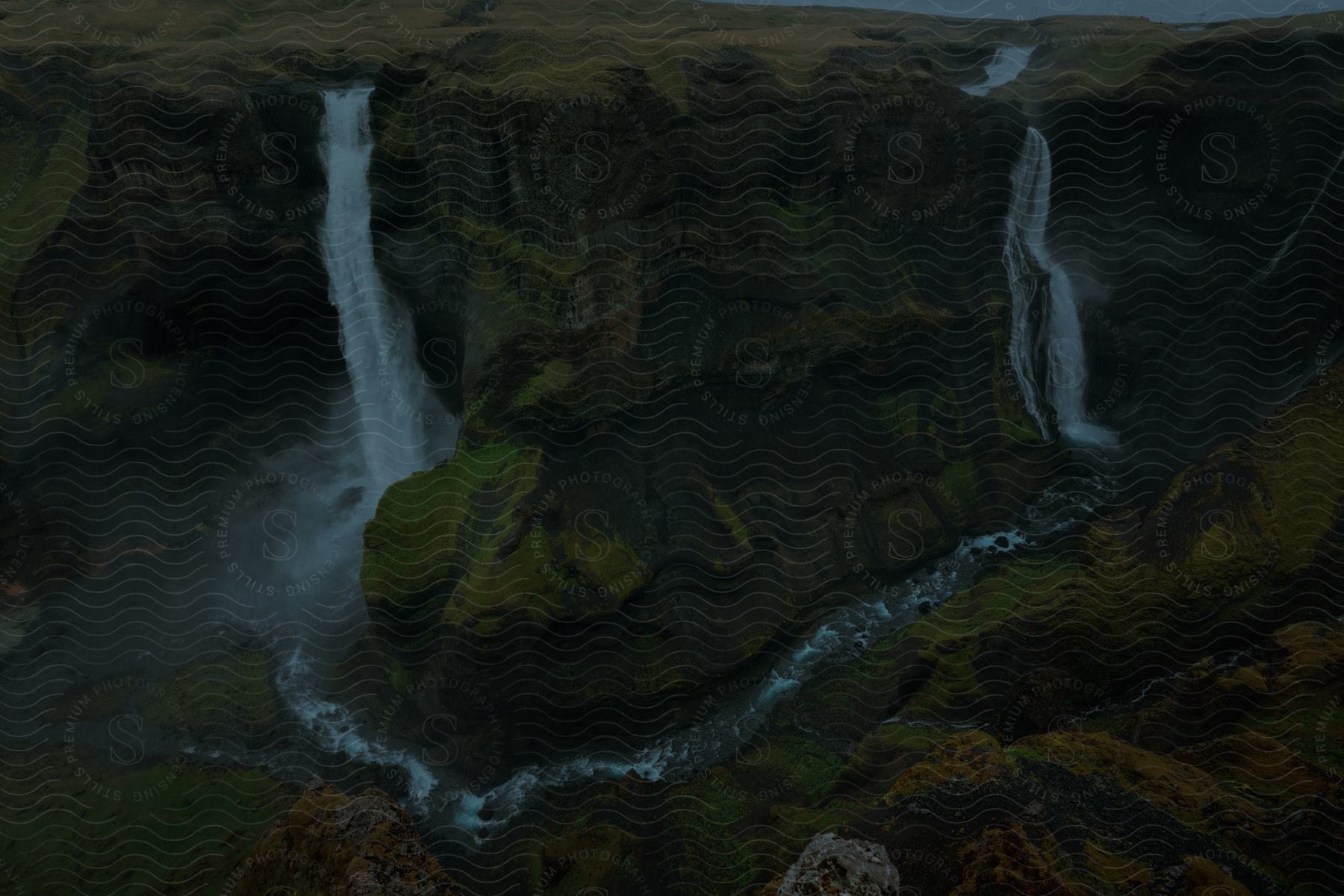 Haifoss and granni waterfalls crashing from a plateau into the canyon of river fossa in iceland