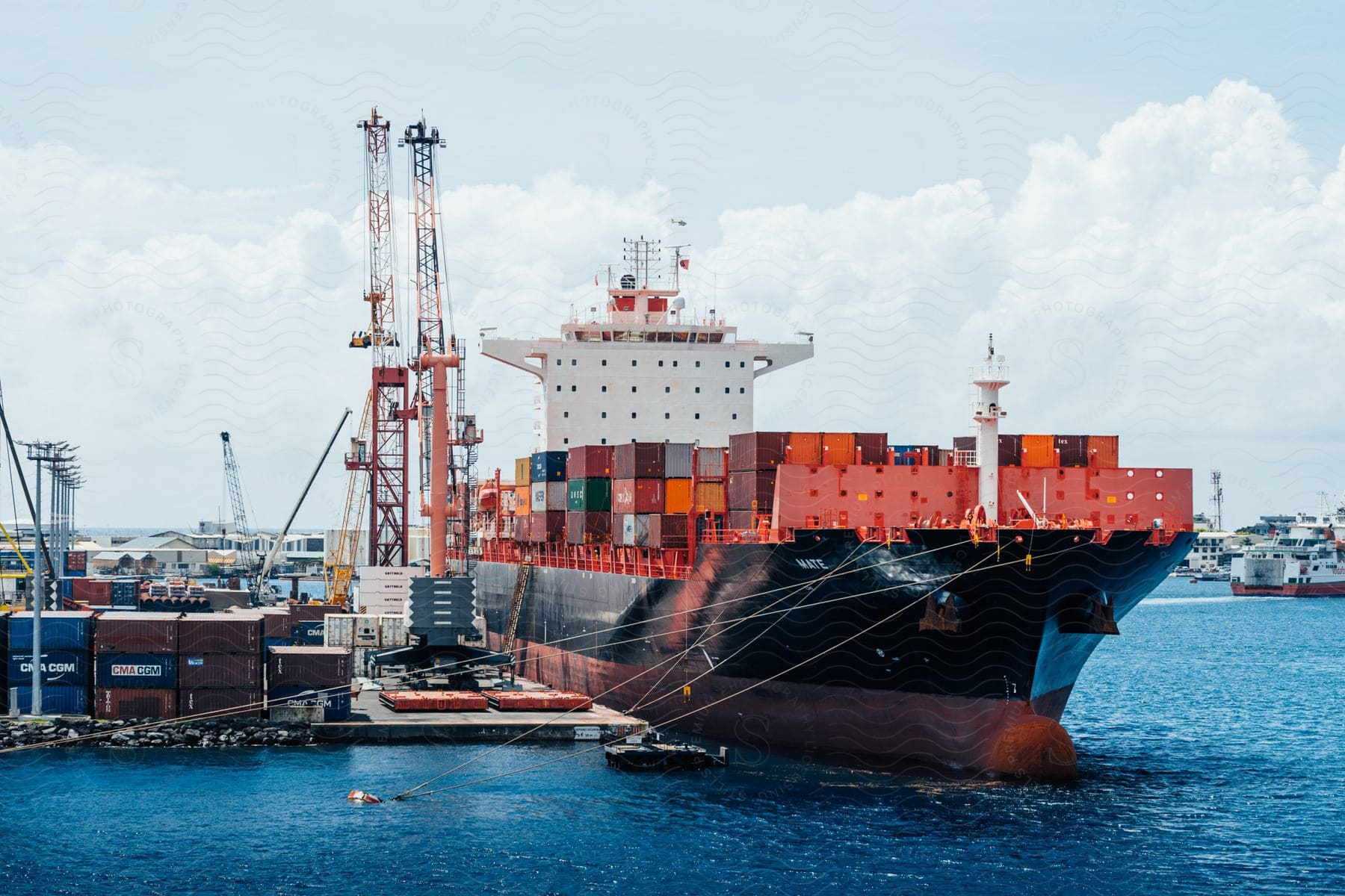 A boat on the water with shipping containers