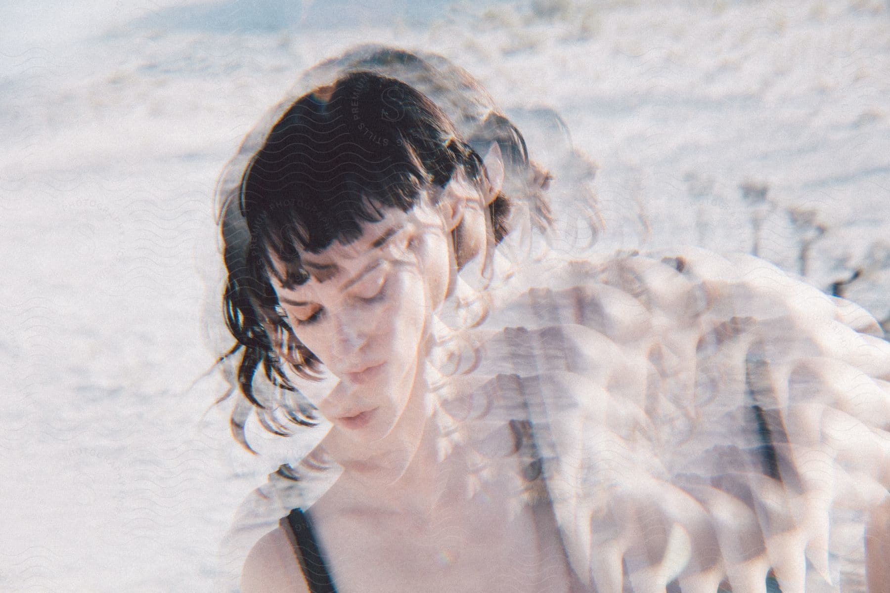 A woman with dark hair captured using multiple exposures