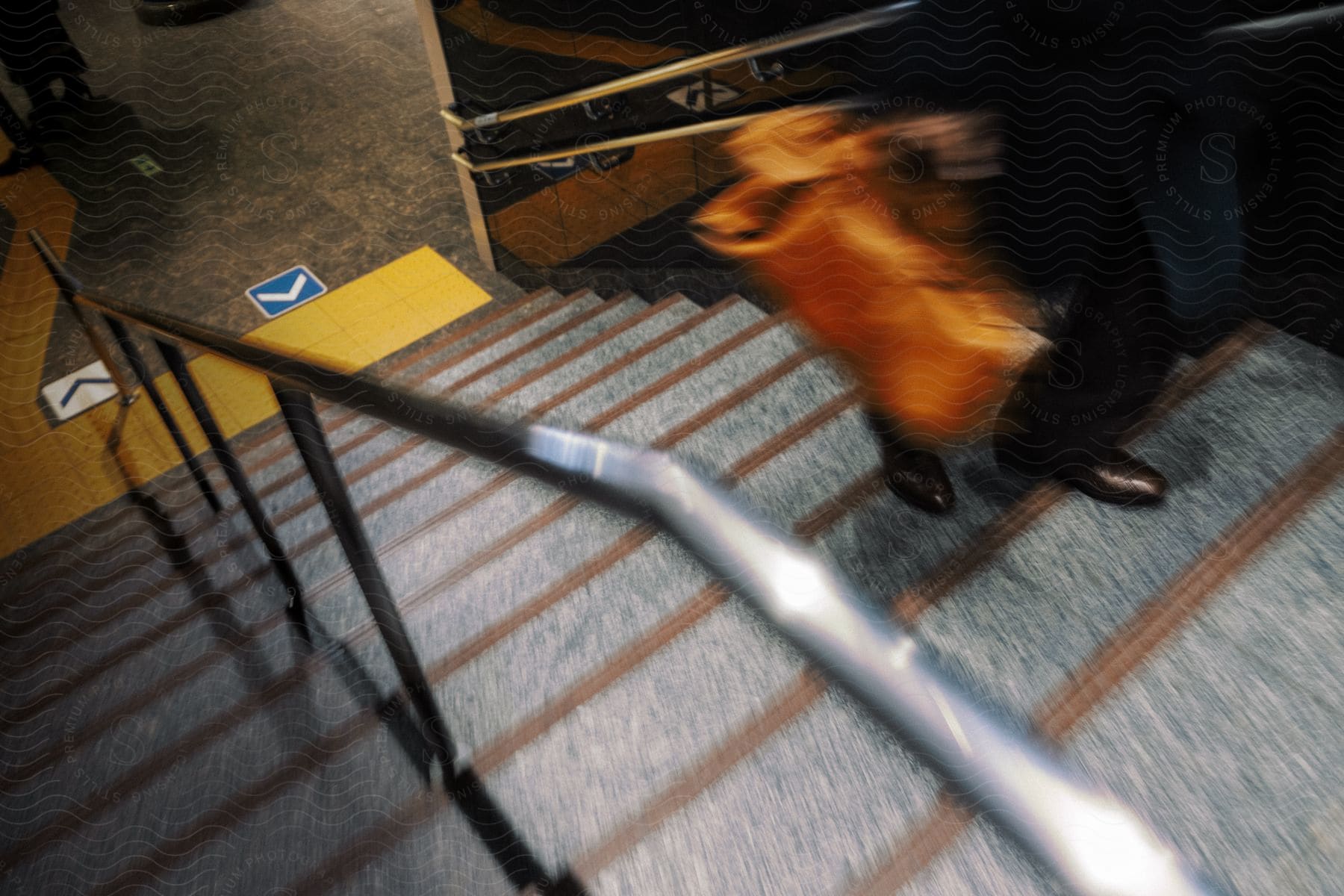 A person carrying a bag walking up steps from the subway