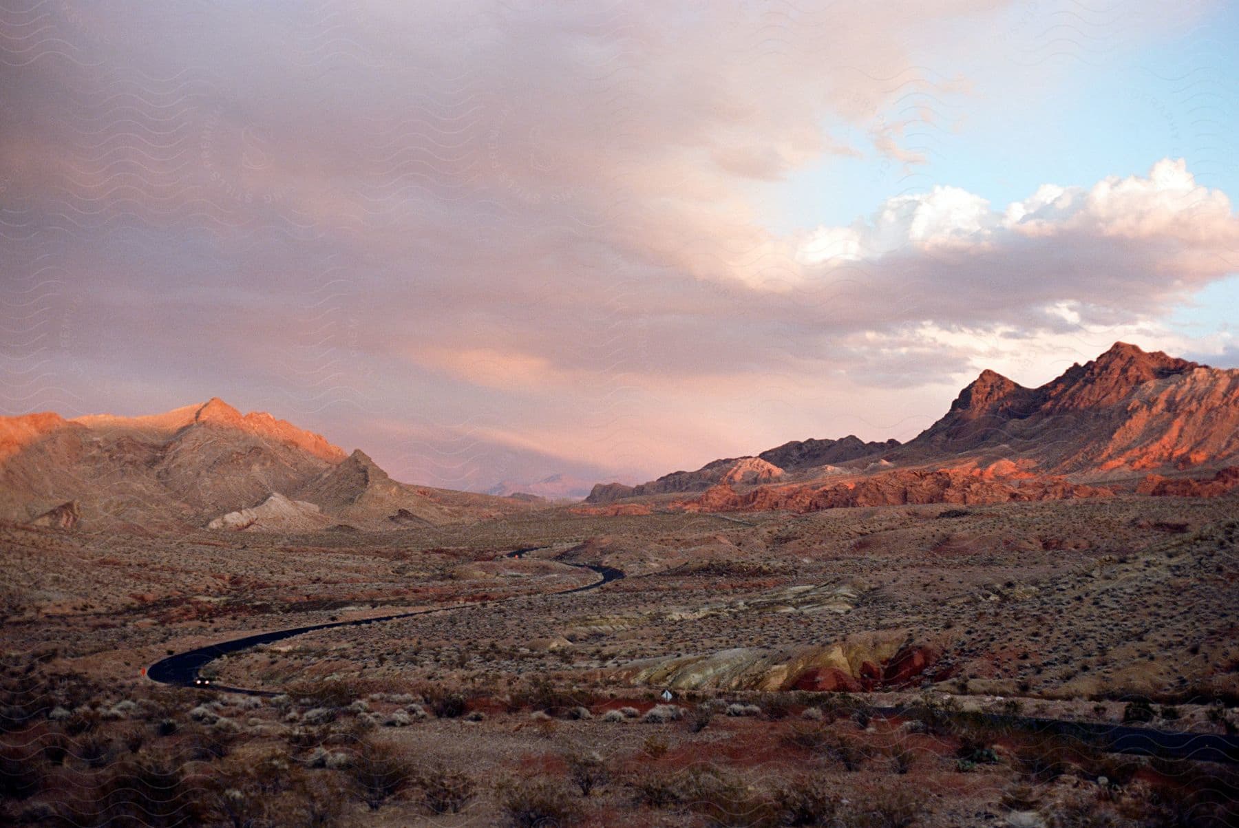 Rugged landscape with car driving on winding road in south west usa