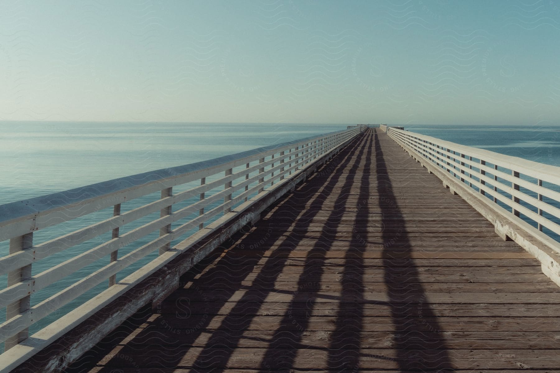 A long pier with guardrails extends into the distance