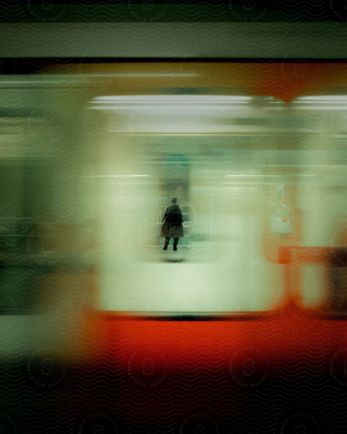 A man in a coat and cap is captured in motion inside a blurry bus creating intrigue and movement