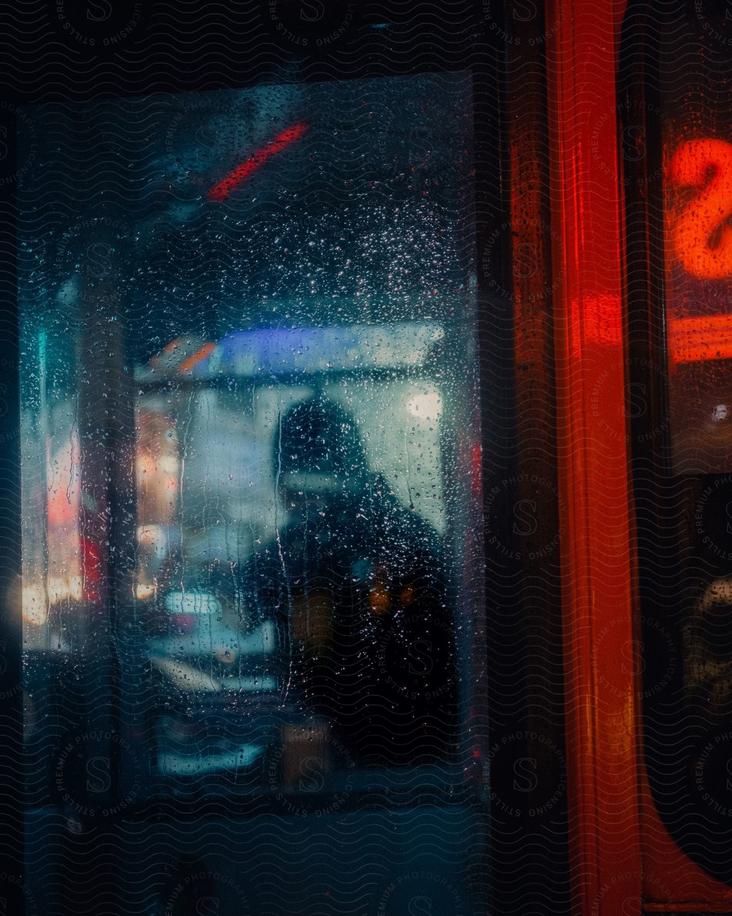 A man sitting in a restaurant during a rainy night