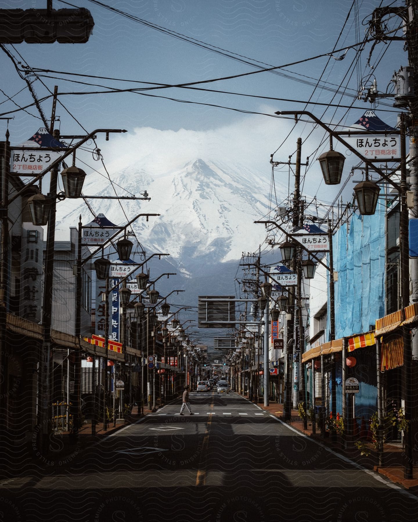 A cityscape with buildings mountains and vehicles