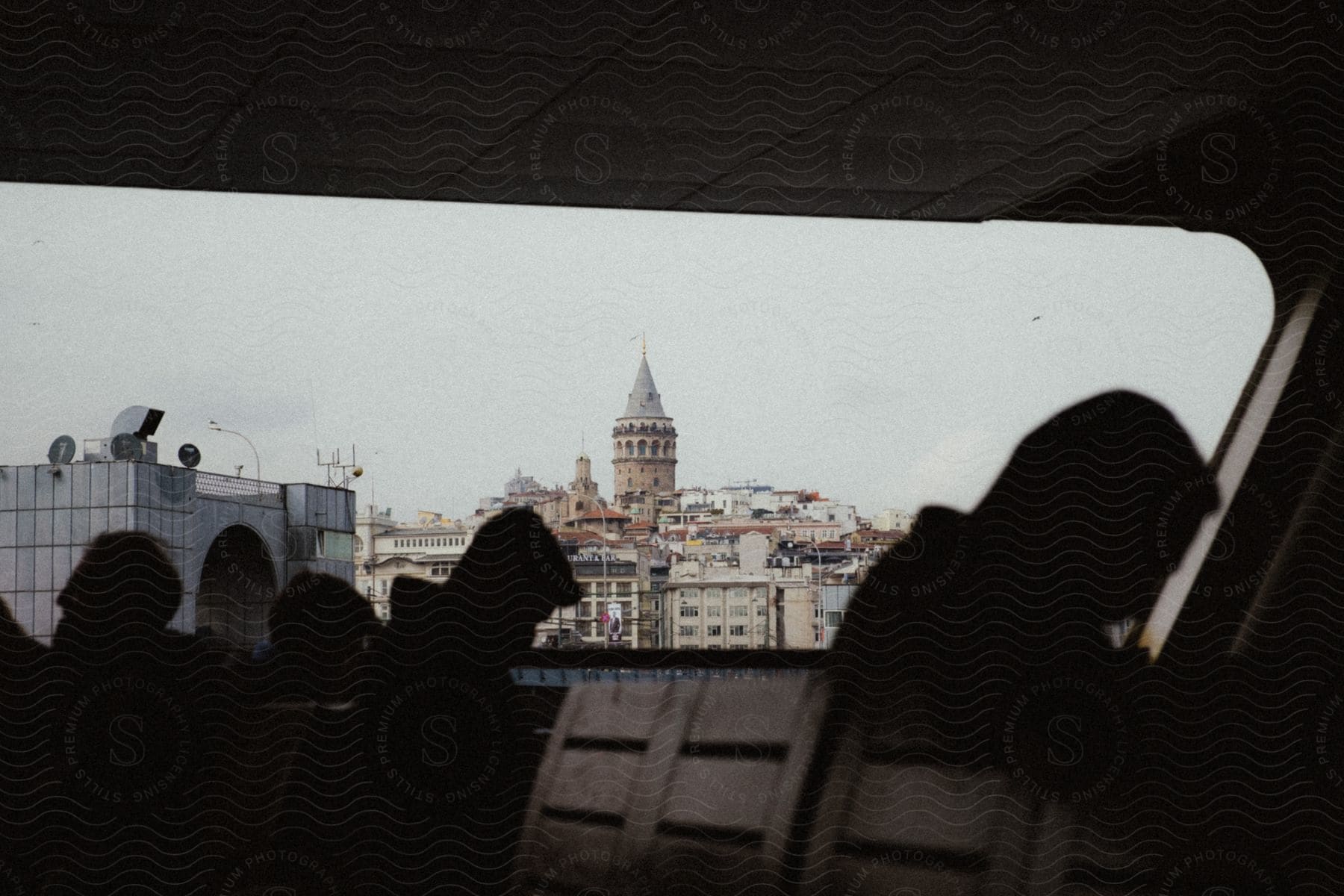 Several men sitting in chairs as a window faces a tourist destination in istanbul