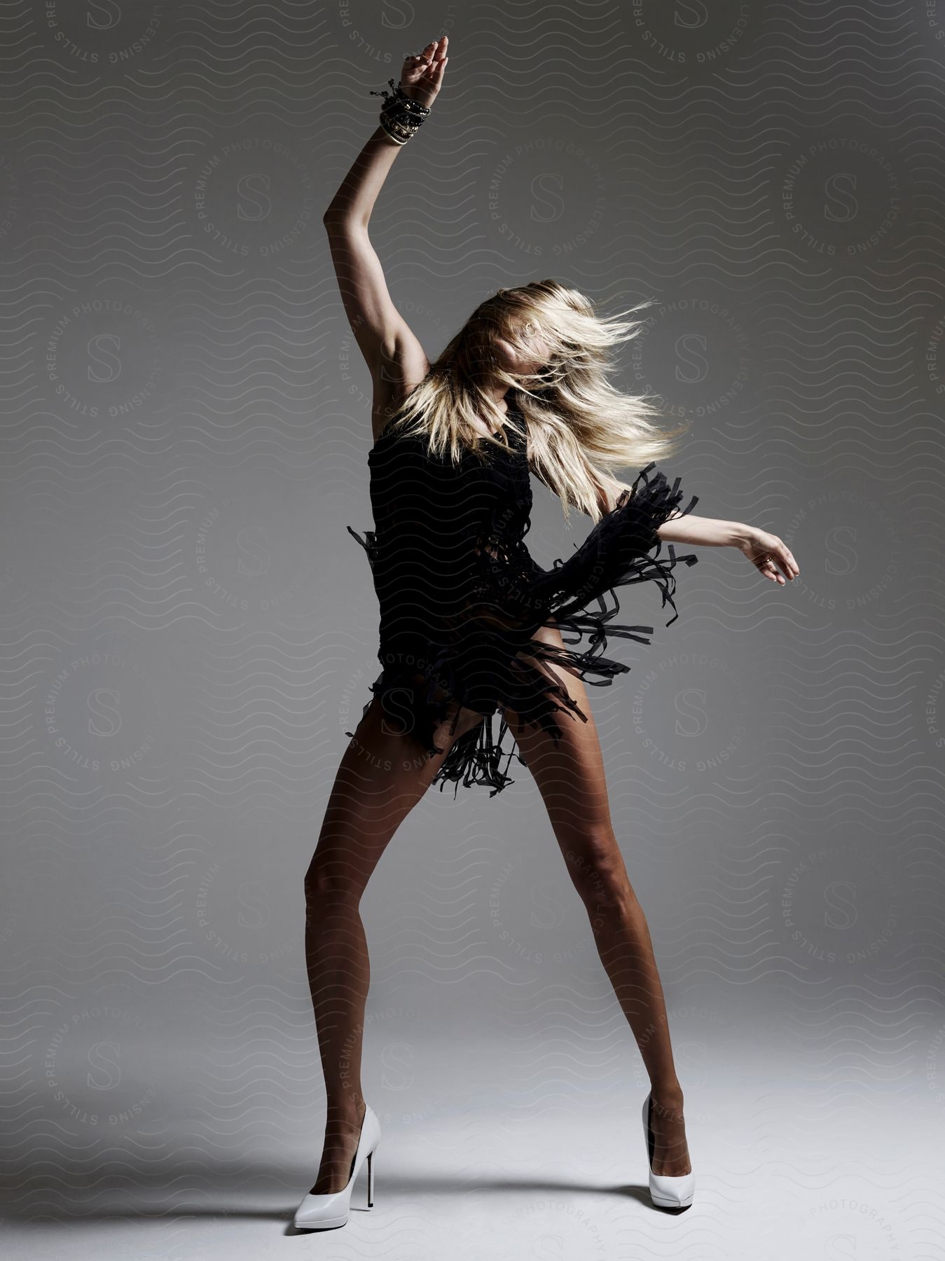 A woman dancing energetically in a studio