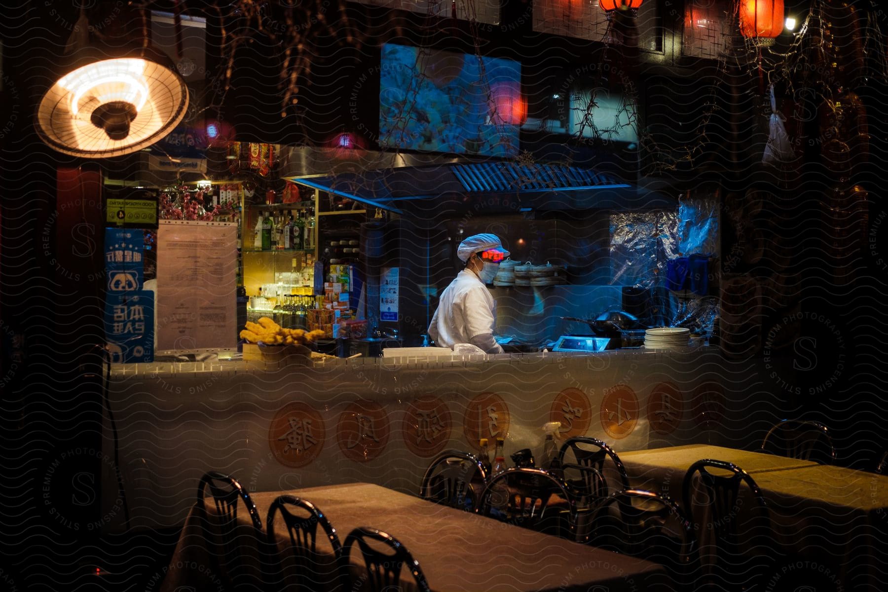 Chef working in the kitchen of an asian fast food place