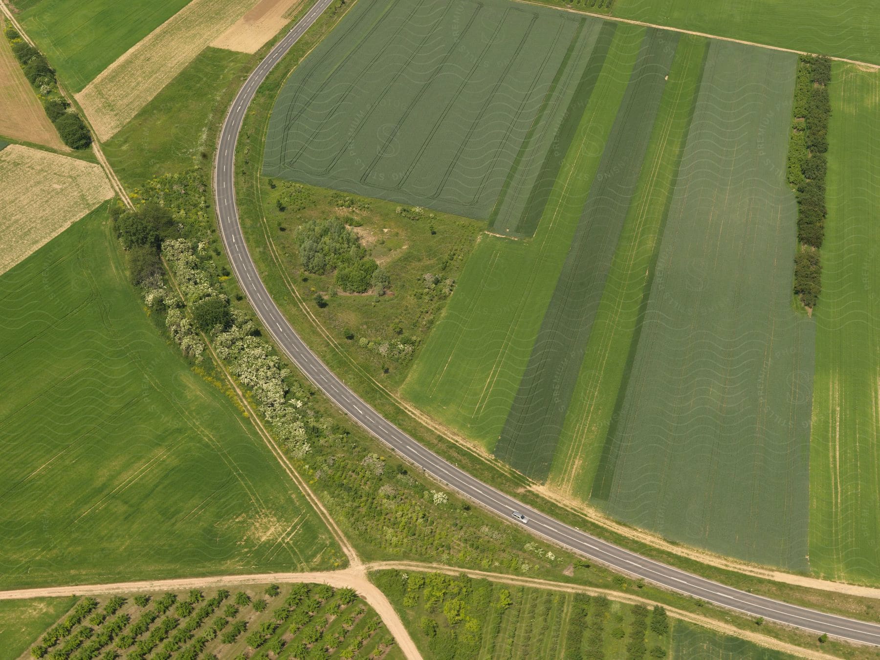 A large field covered in green grass with a road going around it in germany